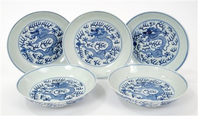 Lot 14 - Set five 19th century Chinese blue and white saucer dishes with painted dragon chasing pearl decoration to front and back and six character Guangxu marks and probably of the period 16.5cm