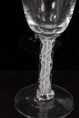 Lot 81 - 18th century wine glass with trumpet bowl and air twist stem on splayed foot 17cm and another with double opaque twist stem 14cm (2)