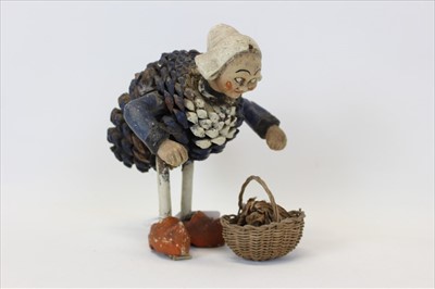 Lot 2033 - Unusual figure of a stooping lady, with pottery head and arms, and body constructed from a painted pine cone. Paper label to base "made in France" approx 20cm in height