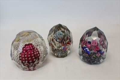 Lot 2063 - Three Bohemian facet cut art glass paperweights (3)