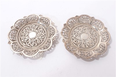 Lot 540 - Pair of late 19th/early 20th century Indian white metal dishes of flower head form.