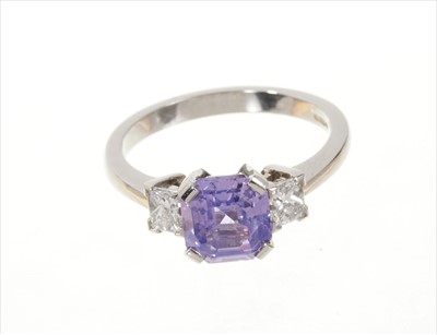 Lot 719 - Natural purple sapphire and diamond three stone ring with an octagonal cut natural purple Ceylon sapphire weighing 2.48cts flanked by two princess cut diamonds in platinum setting. Estimated total...