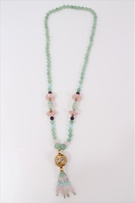 Lot 3280 - Green hard stone bead necklace decorated with rose quartz beads and gilt floral enamelled large bead with beaded tassel finial