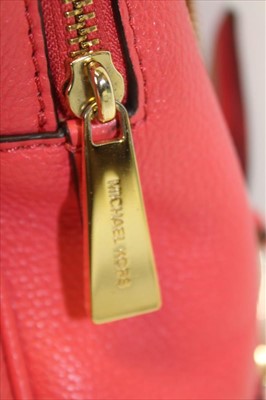 Lot 3112 - Michael Kors Pink leather back pack with engraved zipper pulls and circular logo lining.