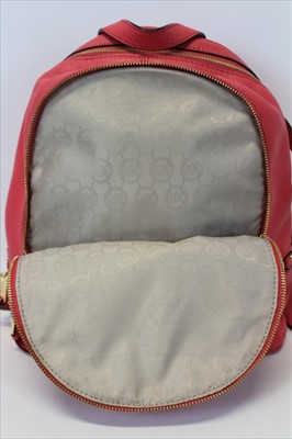 Lot 3112 - Michael Kors Pink leather back pack with engraved zipper pulls and circular logo lining.