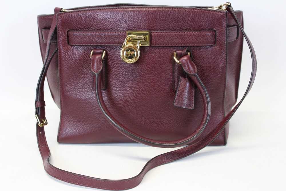 Lot 3114 - Michael Kors mulberry leather handbag with logo padlock to front. Engraved zipper pull and MK logo lining. Plus Michael Kors soft dust bag.