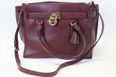 Lot 3114 - Michael Kors mulberry leather handbag with logo padlock to front. Engraved zipper pull and MK logo lining. Plus Michael Kors soft dust bag.