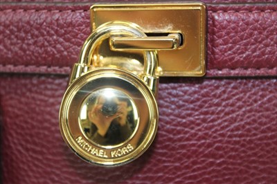 Lot 3114 - Michael Kors mulberry leather handbag with logo padlock to front. Engraved zipper pull and MK logo lining. Plus Michael Kors soft dust bag.