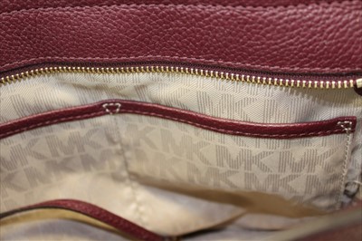 Lot 3114 - Michael Kors mulberry leather handbag with logo padlock to front. Engraved zipper pull and MK logo lining. Plus Michael Kors soft dust bag.