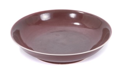 Lot 43 - Fine Chinese Qing dynasty aubergine glazed saucer dish, finely potted with rounded sides and flared rim, on a short foot, with Daoguang seal mark in underglaze blue