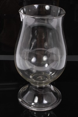 Lot 84 - Georgian glass storm lamp, of baluster form on splayed foot with rough pontil mark, 30cm height