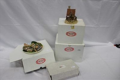 Lot 2164 - Collection of boxed David Winter cottage ornaments, to include Arches Thrice, Lace Makers Cottage, On The Riverbank, Scrooge's Family Home Plaque, and Eggars Hill Christmas plaque (5)