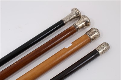 Lot 3690 - Victorian silver mounted Malacca walking stick (London 1884) together with an early 20th century walking stick with ebonised shaft and foliate engraved silver top (London 1922) anothe...