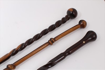 Lot 3680 - Exotic wood walking stick with carved knot and rondel handle together with two others with carved twisted decoration 91cm, 87.5cm and 97cm overall length respectively