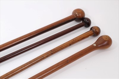 Lot 3675 - Tall exotic wood walking stick with rondel handle 109cm overall length together with three others 87cm to 90cm overall length