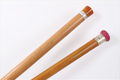 Lot 3666 - Victorian Malacca walking cane with silver collar (London 1881) and floral porcelain knop together with another Continental Malacca Torch stick with removable Amber coloured knop concealing the bu...