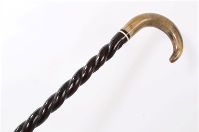 Lot 3668 - Late 19th century heavy walking stick with twisted ebonised shaft inset with ivory washer and horn crook handle, 92cm overall length