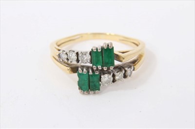 Lot 3433 - 18ct gold emerald and diamond cross-over ring with four step cut emeralds and graduated brilliant cut diamonds in claw setting on gold shank