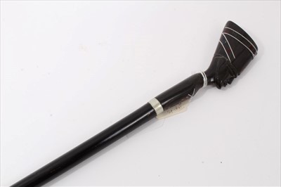 Lot 3704 - Unusual early 20th century walking stick with ebonised shaft and horn handle carved in the form of an Egyptian Pharaoh's head inlaid with wire and coloured stones, 93cm overall length