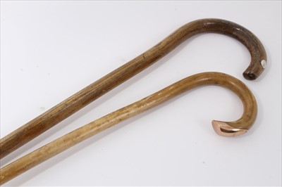 Lot 3707 - Early Edwardian Brigg "fertility" walking stick made from a bull's pizzle with crook handle and 12ct gold end cap (London 1902) 87.5cm overall length, together with another of plain form 90.5cm ove...