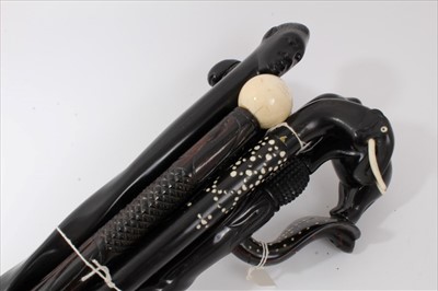 Lot 3710 - Early 20th century heavy carved Indian ebony Elephant stick with inlaid ivory decoration  together  with another similar and three other carved ebony walking stick, various lengths