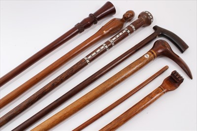 Lot 3711 - Two Pitcairn Islands walking stick possibly Prisoner of War work, another stick with crutch handle and inlaid initial, stick with inlaid Mother of Pearl decoration, one other with carved decoration...
