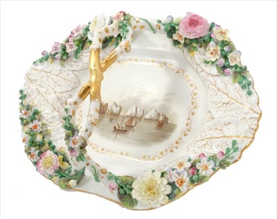 Lot 31 - 19th century Rockingham basket, circa 1835, with moulded leaves, crossed branch handle and encrusted flower decoration, the centre with a painted view of The Needles, Isle of Wight, titled on the r...