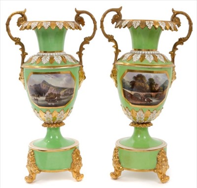 Lot 48 - Good pair of early 19th century Crown Derby twin-handled baluster vases, on circular bases with paw feet, painted with panels entitled 'View of Spain' and 'View of Wales', on a pale green ground, i...