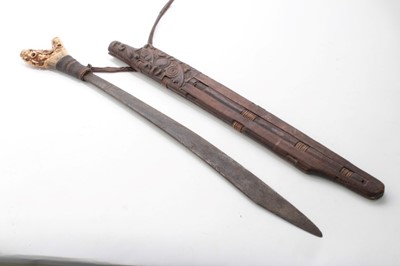 Lot 717 - Borneo Dayak Head hunters sword with carved bone hilt with rope bound grip, in carved wood scabbard
