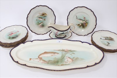 Lot 50 - Late Victorian Royal Worcester porcelain fish service, each piece with overpainted transfer decoration depicting various fishes and gilded cobalt blue gadrooned edging  - comprising twelve plates,...
