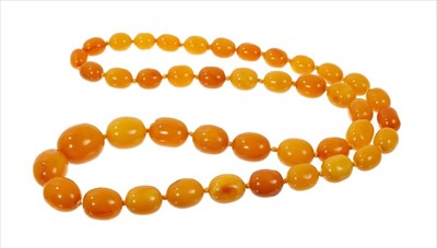 Lot 487 - Old amber necklace with a string of graduated butterscotch amber beads measuring approximately 25mm x 21mm to 13mmx 11mm. Gross weight approximately 102 grams