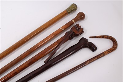 Lot 724 - Novelty carved hardwood stick, with carved shoe handle, 83cm long, together with 19th century malacca cane with embossed brass mushroom form handle, alpine style stick with pyrographed handle, bone...