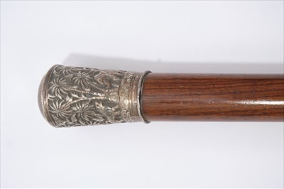 Lot 723 - Impressive 19th century Anglo-Indian silver mounted walking stick, the silver terminal embossed with a continuous frieze of animals in a jungle, tapering rosewood staff, 89cm long