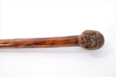 Lot 336 - Good early carved hardwood and bamboo walking stick, the wooden terminal carved with figurehead, on mottled tapering shaft, 83cm long
