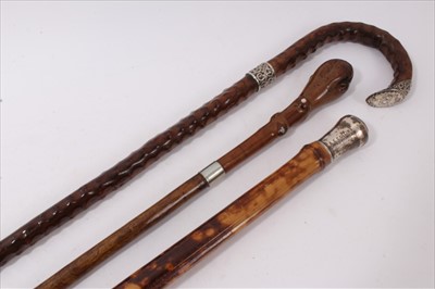 Lot 737 - Unusual Victorian  'Congo cane ' and silver mounted walking stick, with crook handle and silver mounts engraved with initials H. J. and assayed for London 1896, together with unusual white metal mo...