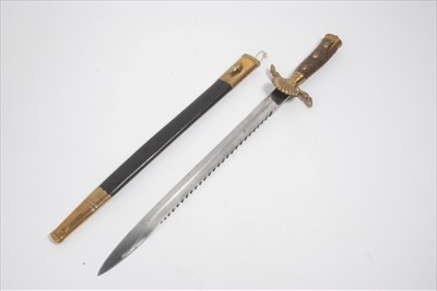Lot 757 - 1930s German hunting Association sidearm with stag horn grip and brass acorn and hoof terminals , shell guard,saw back blade by Carl Eickhorn,Solingen in brass mounted leather scabbard.
