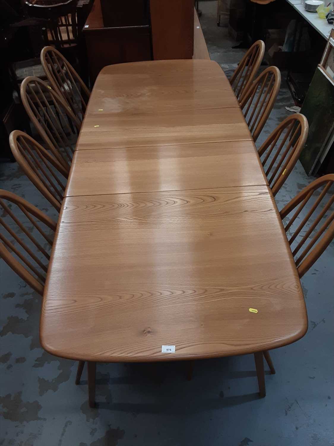 Lot 975 - Ercol extending dining table with two extra leaves and set of eight ensuite chairs