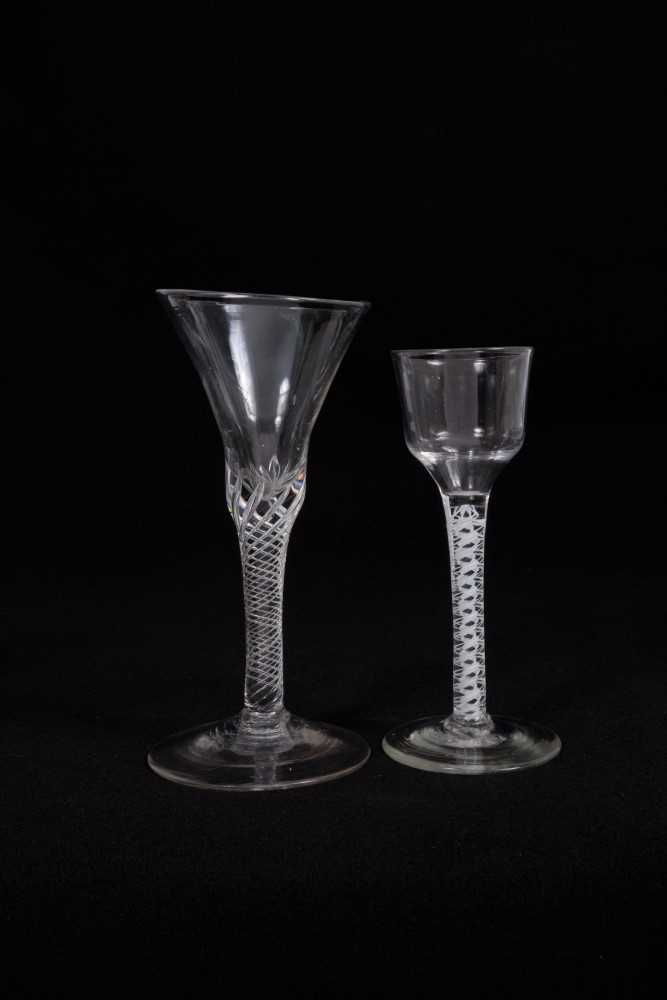 Lot 14 - 18th century wine glass with multi-spiral airtwist stem, together with an 18th century opaque twist glass with ogee bowl (2)