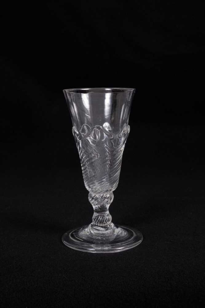 Lot 10 - Georgian flamiform wrythen ale glass, the moulded round funnel bowl on a folded conical foot, circa 1750, 13.75cm height