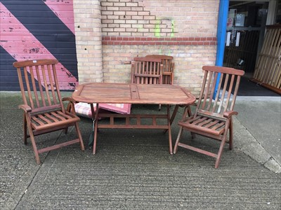Lot 1067 - Garden dining table and set of four chairs with covers
