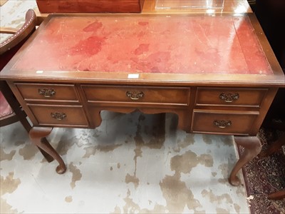 Lot 961 - Walnut kneehole writing table with inset leather lined top, five drawers below on cabriole legs