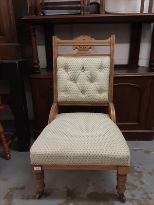 Lot 1029 - Late Victorian chair with buttoned upholstery on turned front legs and castors