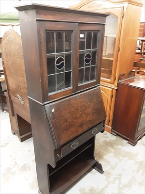 Lot 1034 - Early 20th century oak bureau bookcase with two leaded glazed doors above, writing compartment, single drawer and open shelves below