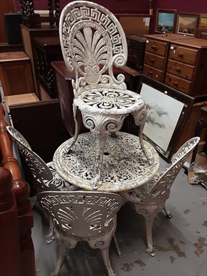 Lot 1053 - Wrought iron circular garden table and set of four chairs