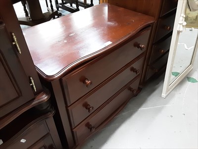 Lot 1054 - Stained pine chest of three drawers and pair of matching bedside chests