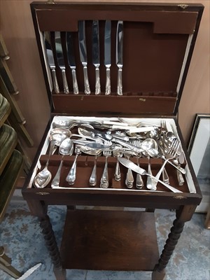 Lot 104 - Canteen of plated cutlery in oak cabinet with spiral twist legs
