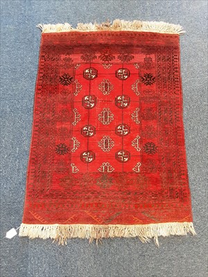 Lot 1077 - Eastern rug with geometric decoration on red ground