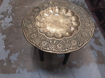 Lot 1091 - Brass topped occasional table on folding base and a brass magazine rack