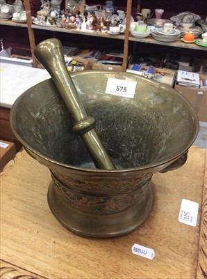 Lot 575 - Brass pestle and mortar with cast decoration and date 1417