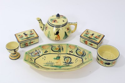Lot 86 - Collection of Quimper faience pottery, painted with figures and foliate patterns on a yellow ground, including a teapot, egg cup, boxes, dish and a ramekin, all marked